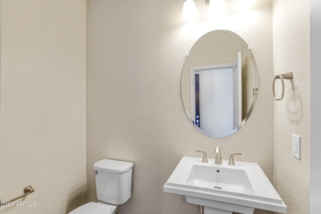 half bathroom with a sink and toilet