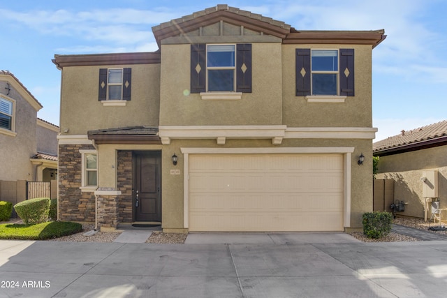 multi unit property featuring an attached garage, concrete driveway, and stucco siding