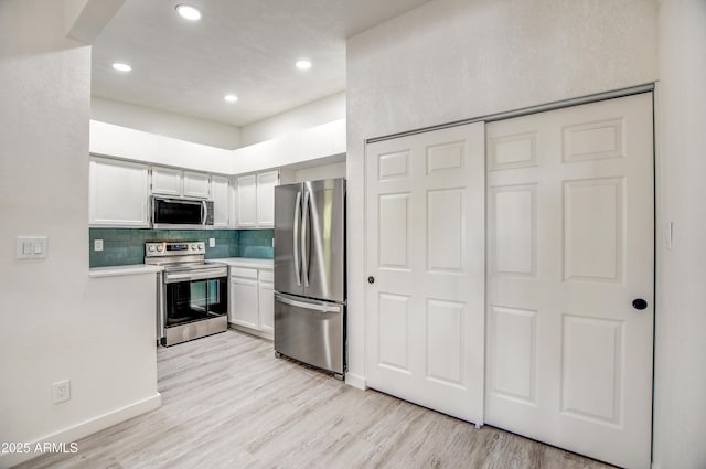 7300 N Dreamy Draw Dr Unit 202, Phoenix, AZ 85020 - kitchen featuring appliances with stainless steel finishes, light countertops, backsplash, light wood-type flooring, and recessed lighting