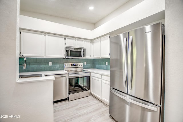 7300 N Dreamy Draw Dr Unit 202, Phoenix, AZ 85020 - kitchen with stainless steel appliances, light countertops, backsplash, light wood-style floors, and recessed lighting