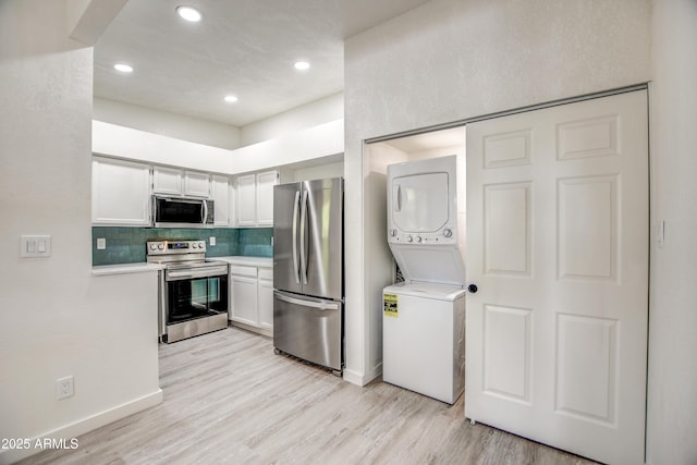 7300 N Dreamy Draw Dr Unit 202, Phoenix, AZ 85020 - kitchen with appliances with stainless steel finishes, stacked washer / drying machine, light countertops, light wood-style flooring, and recessed lighting
