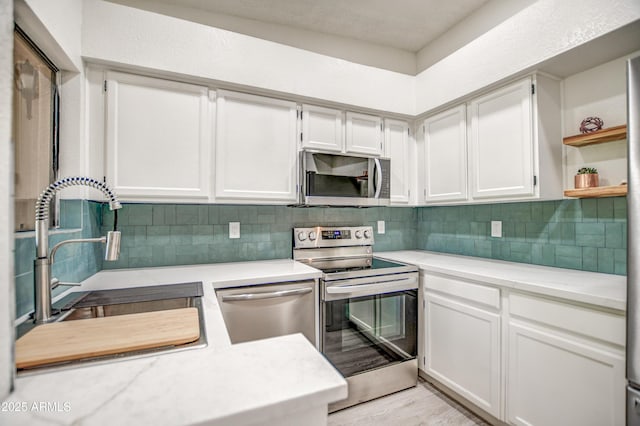 7300 N Dreamy Draw Dr Unit 202, Phoenix, AZ 85020 - kitchen featuring stainless steel appliances, light countertops, tasteful backsplash, and open shelves