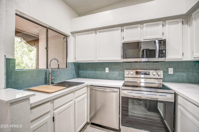 7300 N Dreamy Draw Dr Unit 202, Phoenix, AZ 85020 - kitchen with appliances with stainless steel finishes, backsplash, and white cabinetry
