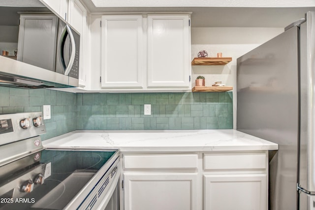 7300 N Dreamy Draw Dr Unit 202, Phoenix, AZ 85020 - kitchen with stainless steel appliances, white cabinets, tasteful backsplash, open shelves, and light stone counters