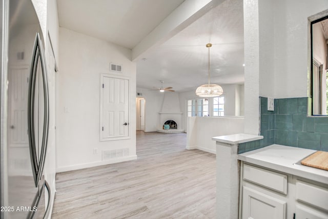 7300 N Dreamy Draw Dr Unit 202, Phoenix, AZ 85020 - kitchen featuring freestanding refrigerator, light wood-style flooring, light countertops, white cabinets, and ceiling fan