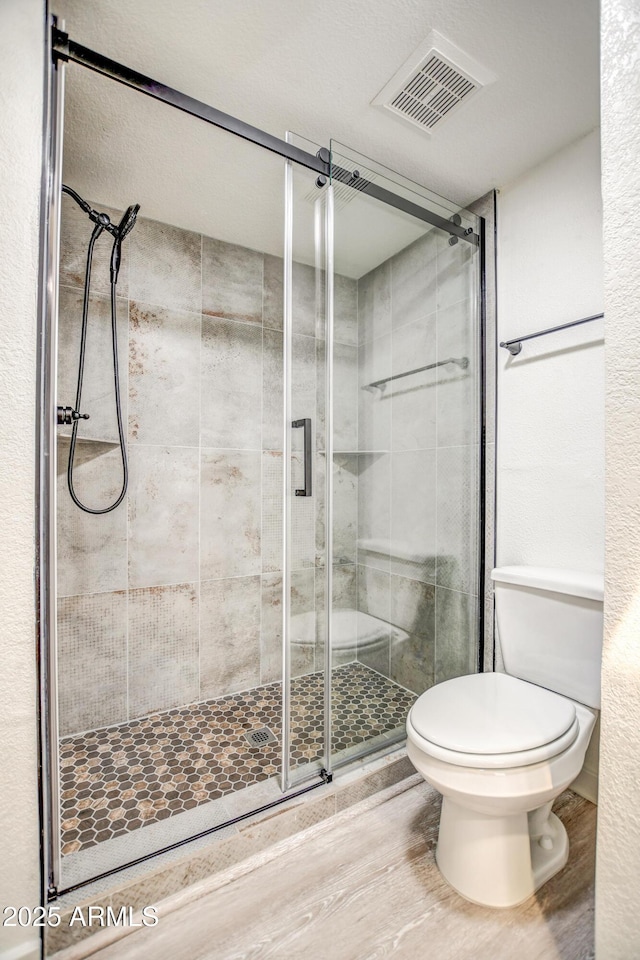 7300 N Dreamy Draw Dr Unit 202, Phoenix, AZ 85020 - full bathroom featuring a shower stall and wood finished floors