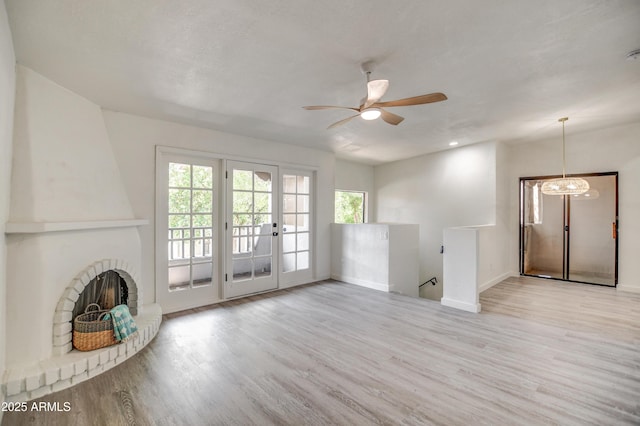 7300 N Dreamy Draw Dr Unit 202, Phoenix, AZ 85020 - unfurnished living room featuring wood finished floors, a ceiling fan, and a fireplace