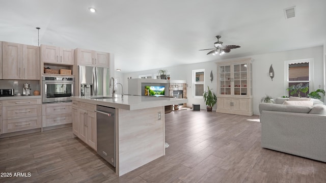 4073 E Stable Ct, Gilbert, AZ 85297 - kitchen featuring appliances with stainless steel finishes, open floor plan, a sink, and light brown cabinetry