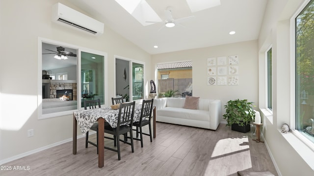 4073 E Stable Ct, Gilbert, AZ 85297 - dining room with an AC wall unit, a ceiling fan, wood finished floors, lofted ceiling, and a skylight