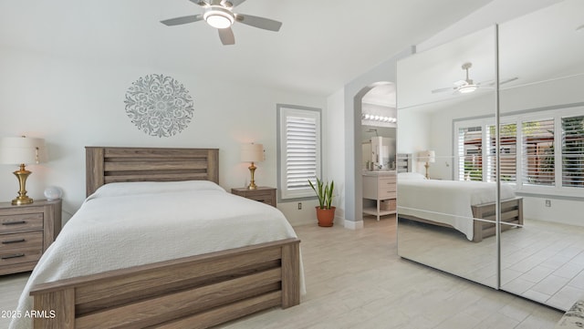 4073 E Stable Ct, Gilbert, AZ 85297 - bedroom with lofted ceiling, arched walkways, baseboards, light wood-type flooring, and a ceiling fan