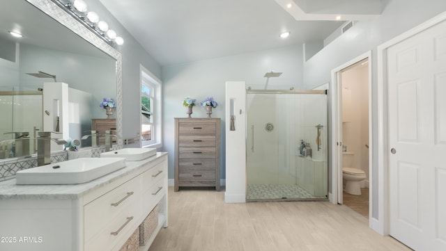 4073 E Stable Ct, Gilbert, AZ 85297 - full bathroom with a shower stall, double vanity, toilet, and wood finished floors