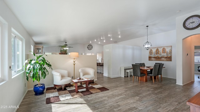 4073 E Stable Ct, Gilbert, AZ 85297 - living room featuring wood finished floors, arched walkways, baseboards, and lofted ceiling
