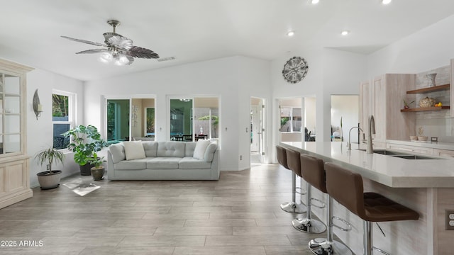 4073 E Stable Ct, Gilbert, AZ 85297 - living area with vaulted ceiling, a ceiling fan, recessed lighting, and light wood-style flooring