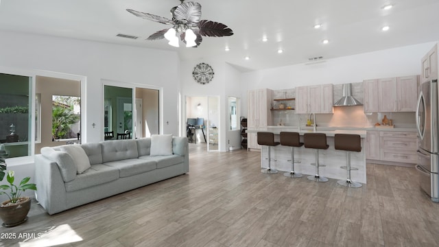 4073 E Stable Ct, Gilbert, AZ 85297 - living area featuring light wood-type flooring, a ceiling fan, recessed lighting, and high vaulted ceiling