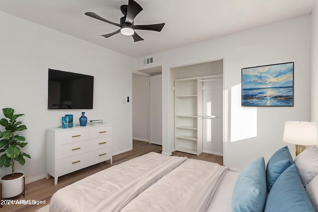 bedroom featuring a closet, hardwood / wood-style flooring, and ceiling fan