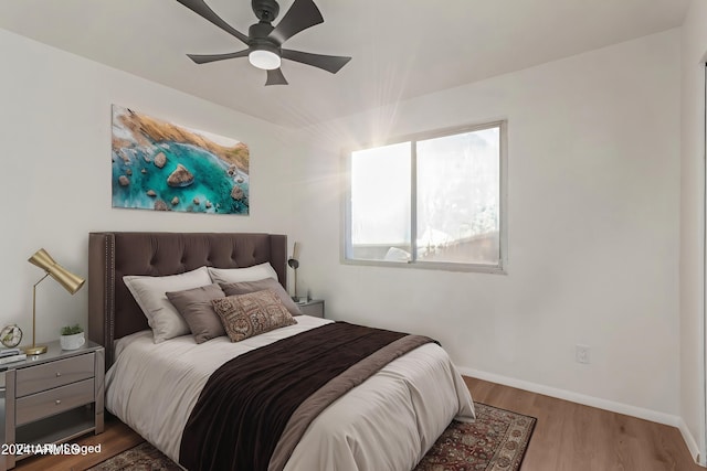 bedroom with ceiling fan and hardwood / wood-style floors