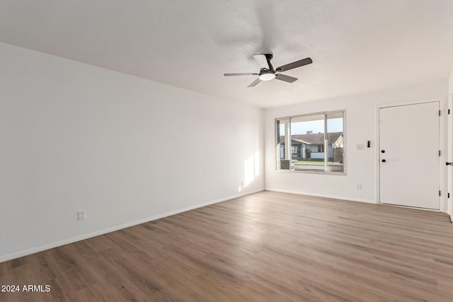 spare room featuring hardwood / wood-style floors and ceiling fan