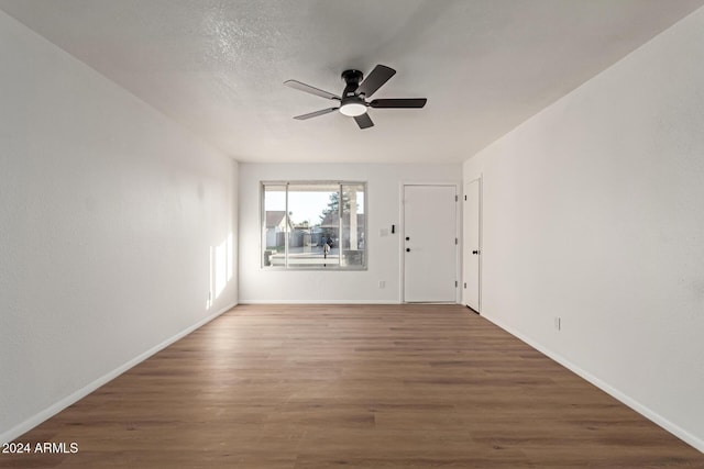 spare room featuring ceiling fan and dark hardwood / wood-style floors