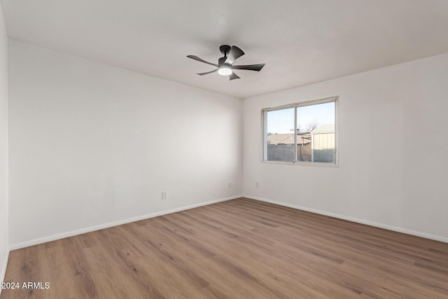 unfurnished room with ceiling fan and light wood-type flooring