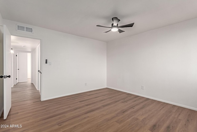 spare room featuring dark hardwood / wood-style floors and ceiling fan