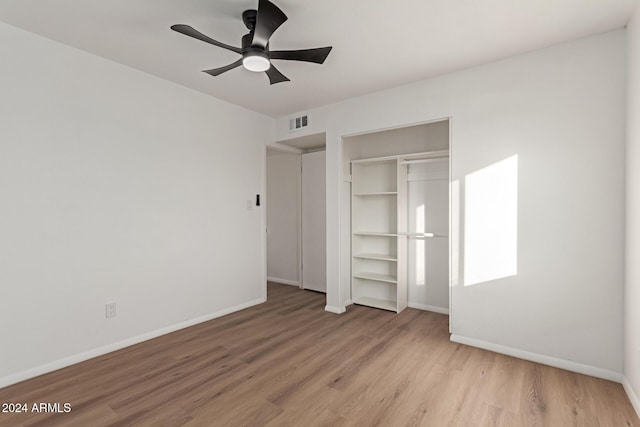 unfurnished bedroom featuring ceiling fan, a closet, and light hardwood / wood-style floors