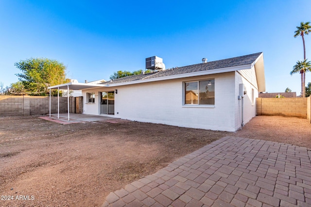 back of property featuring central AC and a patio