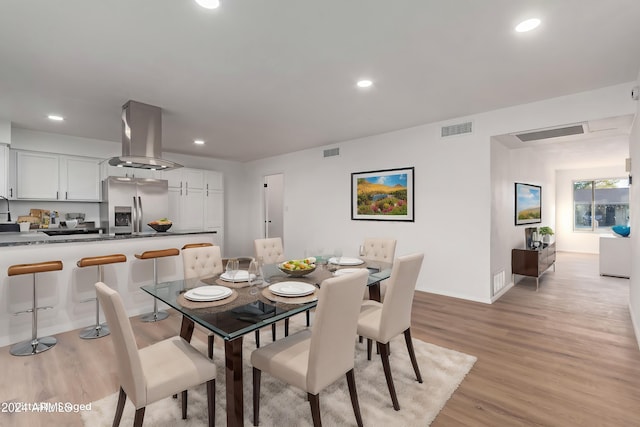 dining room with light hardwood / wood-style flooring