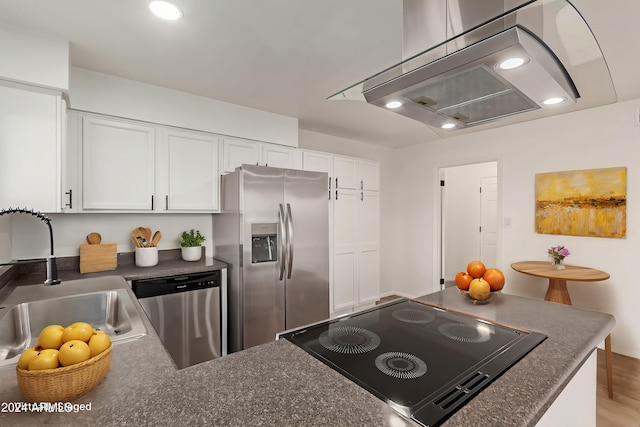 kitchen with island range hood, sink, light hardwood / wood-style floors, white cabinetry, and stainless steel appliances