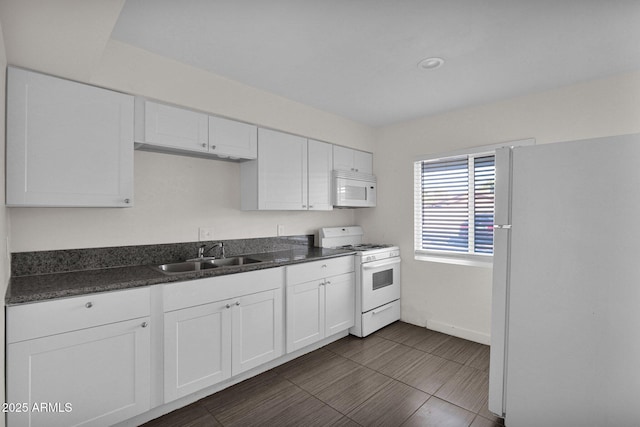 kitchen with white cabinets, sink, and white appliances