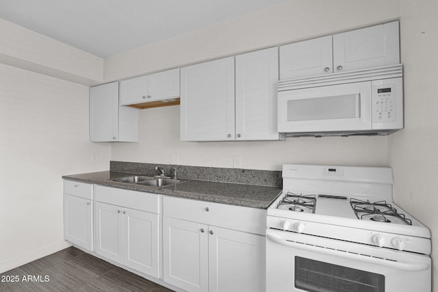 kitchen featuring white cabinets, dark hardwood / wood-style floors, sink, and white appliances