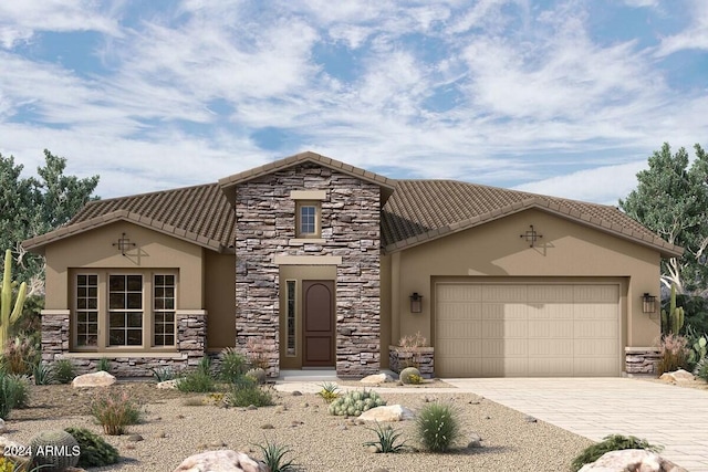 mediterranean / spanish house with stucco siding, a garage, stone siding, a tile roof, and decorative driveway