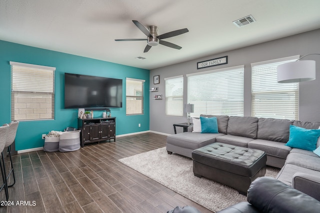 living room with dark wood-type flooring and ceiling fan