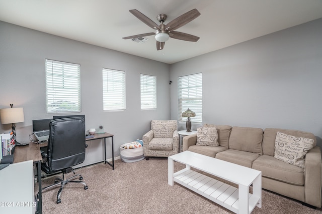 carpeted office space with ceiling fan