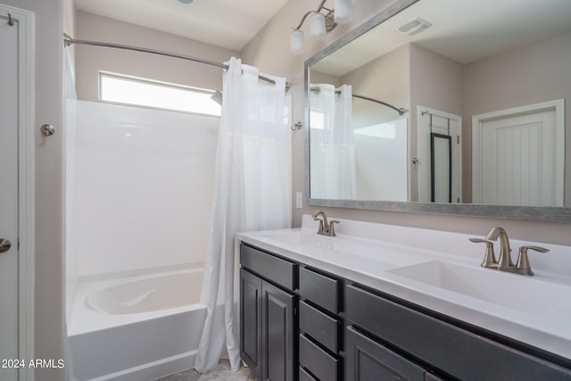 bathroom featuring shower / bath combo and vanity