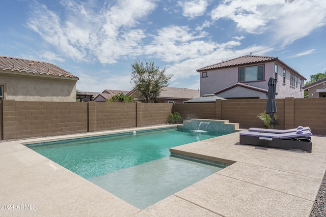 view of swimming pool with a patio and pool water feature