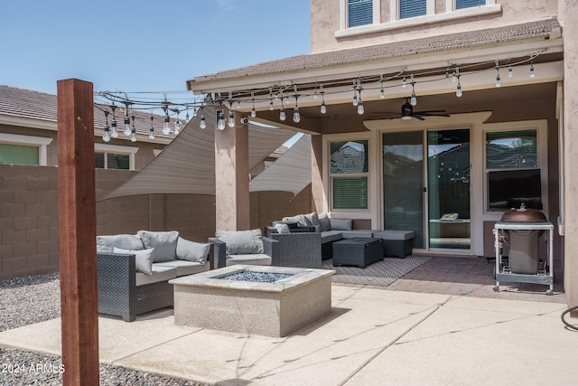 view of patio / terrace with an outdoor living space with a fire pit and ceiling fan