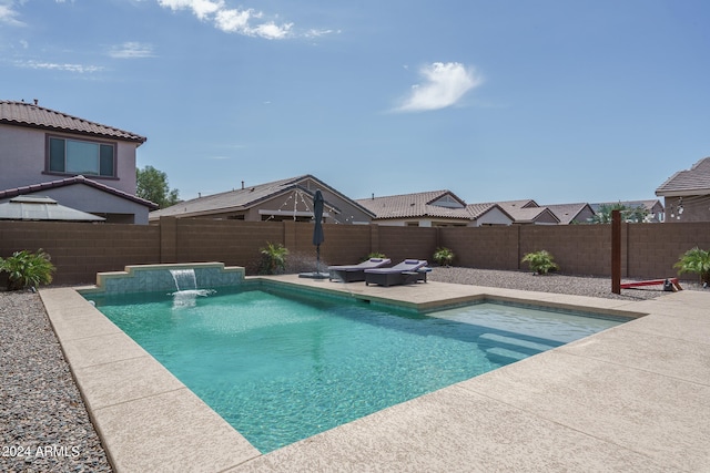 view of pool with pool water feature and a patio