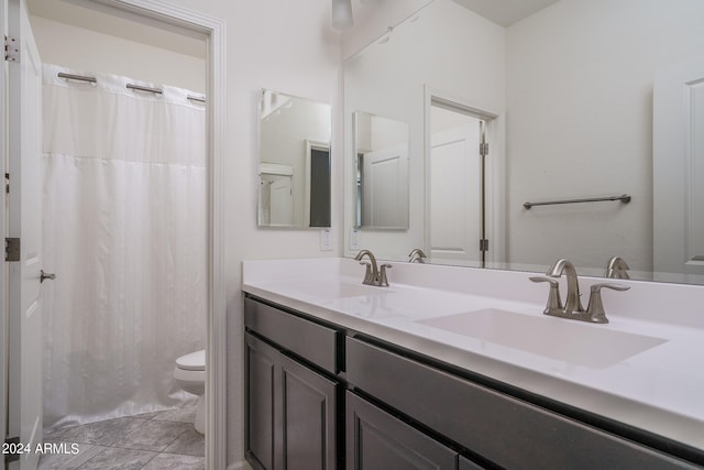 bathroom featuring vanity, toilet, and a shower with shower curtain