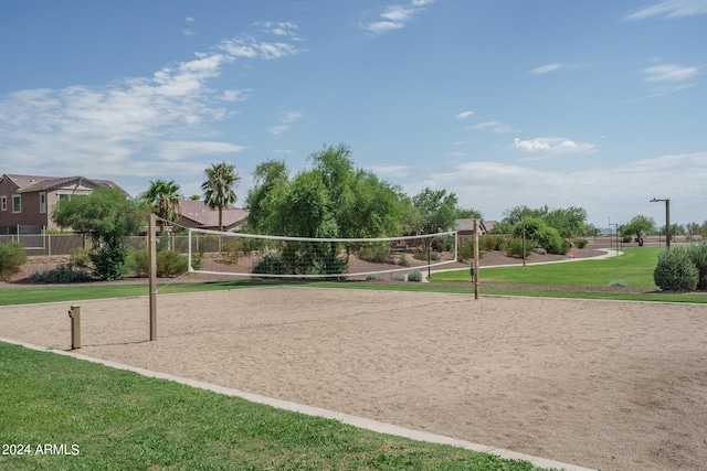 surrounding community featuring volleyball court and a lawn