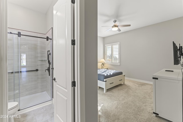 bathroom featuring toilet, an enclosed shower, and ceiling fan