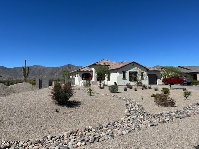 view of front facade featuring a mountain view and a garage