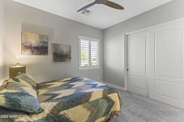 bedroom featuring ceiling fan, carpet floors, and a closet