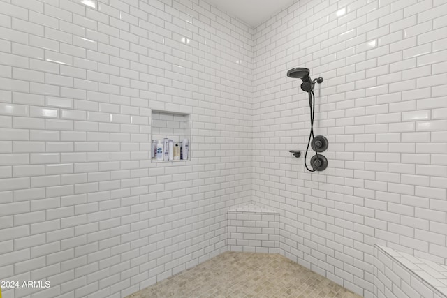 bathroom with tiled shower