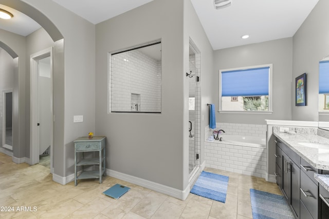 bathroom featuring vanity and separate shower and tub