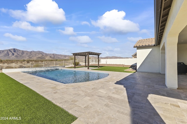 view of swimming pool featuring a yard, a pergola, a mountain view, pool water feature, and a patio area