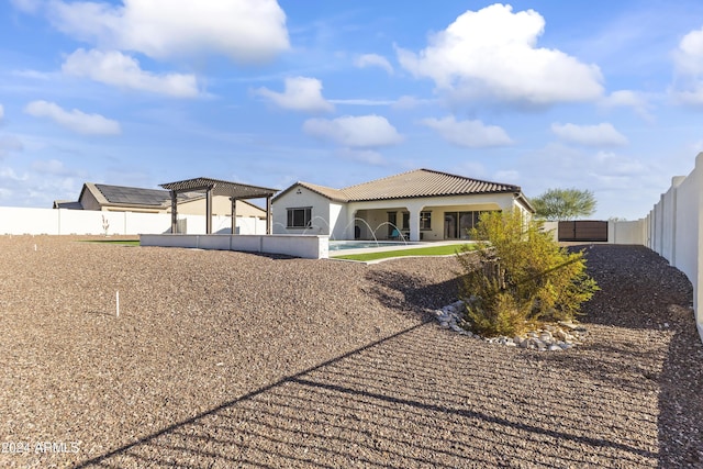 rear view of property featuring a patio area and a pergola