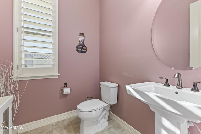 bathroom with tile patterned flooring, toilet, and sink