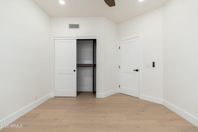 unfurnished bedroom featuring recessed lighting, light wood-style floors, baseboards, ceiling fan, and a closet