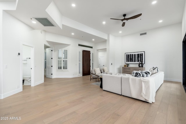 living room with ceiling fan, light wood finished floors, recessed lighting, and baseboards