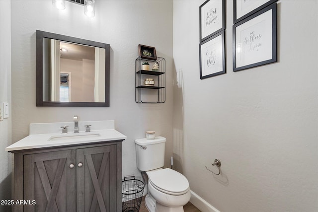 bathroom featuring toilet and vanity